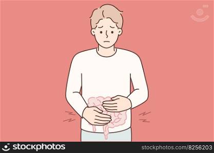 Man puts hands on stomach feeling pain in intestinal due to malnutrition or fast food poisoning. Guy suffering from gastritis or diarrhea causing intestinal problems needs help of gastroenterologist. Man puts hands on stomach feeling pain in intestinal due to malnutrition or fast food poisoning