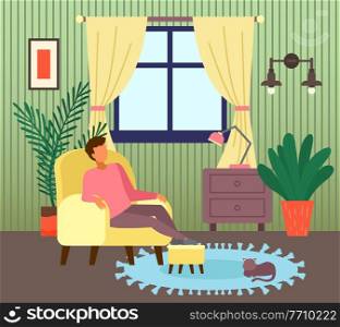 Man sitting at armchair in living room near window. Guy enjoy leisure time, like spend time at home. Cat relaxing at carpet. Indoor recreation at home. Chest of drawers with lamp in room, houseplant. Man sitting at armchair in living room near window, guy enjoy leisure time, like spend time at home