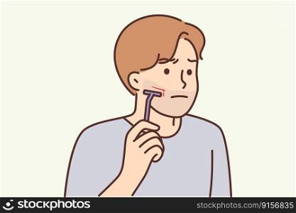 Man using manual razor cuts himself during morning skincare routine. Clumsy young guy who shaves with manual razor inflicted bleeding wound with blade due to carelessness or inexperience . Man using manual razor cuts himself during morning skincare routine due to carelessness 