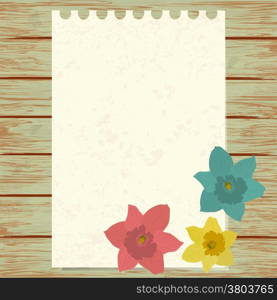 Maple jonquils with paper sheet on wooden background texture