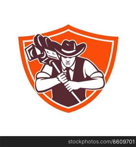 Mascot icon illustration of bust of a cowboy camera operator or cameraman holding a vintage film movie camera viewed from front set in crest shield on isolated background in retro style.. Cowboy Camera Operator Shield