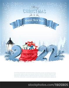 Merry Christmas and Happy New Year 2022. Blue 3D numbers with a red sack full presents on a winter landscape background. Vector