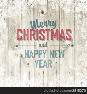 Merry Christmas greeting on blond wooden background