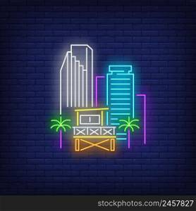 Miami city skyscrapers and lifeguard station neon sign. Beach, tourism, travel design. Night bright neon sign, colorful billboard, light banner. Vector illustration in neon style.