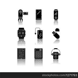 Mobile devices drop shadow black glyph icons set. Pocket electronic gadgets. Smart technology. Powerbank, smartphone, video camera. Flash drive, calculator. Isolated vector illustration on white space