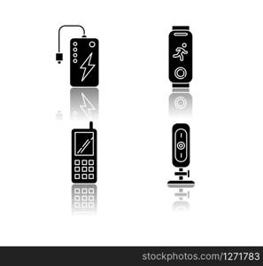 Mobile devices drop shadow black glyph icons set. Pocket electronic gadgets. Smart technology. Powerbank. Fitness tracker. Cell phone, web camera. Isolated vector illustrations on white space