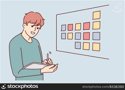 Motivated businessman brainstorm wok with sticky notes on board in office. Male employee or worker involved in creative thinking at workplace. Vector illustration. . Male employee brainstorm near board in office 