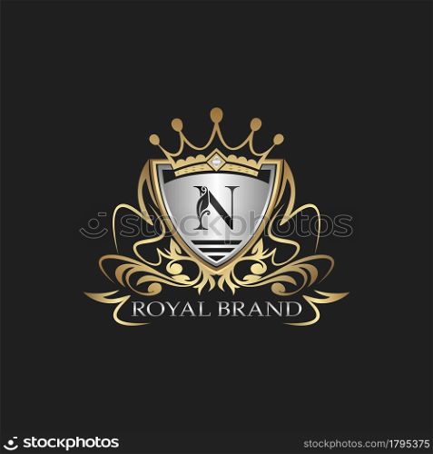 N Letter Gold Shield Logo. Elegant vector logo badge template with alphabet letter on shield frame ornate vector design.