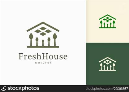 Nature green house logo with tree and leaf shape