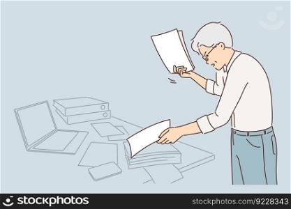 Nervous gray haired office worker doing paperwork and getting angry seeing errors in documentation and reports. Experienced businessman prepares tax returns nervous due to high government fees . Nervous gray haired office worker doing paperwork and getting angry seeing errors in documentation