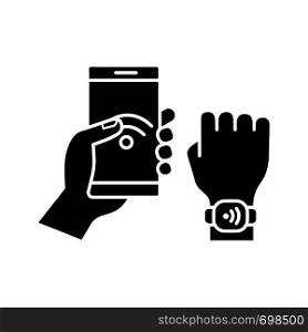 NFC bracelet connected to smartphone glyph icon. NFC phone synchronized with smartwatch. Near field communication.RFID wristband. Silhouette symbol. Negative space. Vector isolated illustration. NFC bracelet connected to smartphone glyph icon
