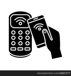 NFC smartphone payment glyph icon. Silhouette symbol. NFC phone and POS terminal. Near field communication. Mobile phone contactless payment. Negative space. Vector isolated illustration. NFC smartphone payment glyph icon