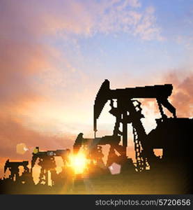 Oil pumps over sunset background. Vector illustration.