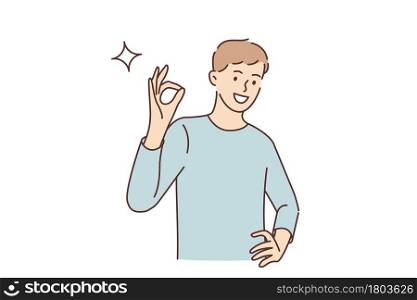 Ok sign and gesture language concept. Young smiling man cartoon character standing showing ok sign with fingers looking at camera vector illustration . Ok sign and gesture language concept