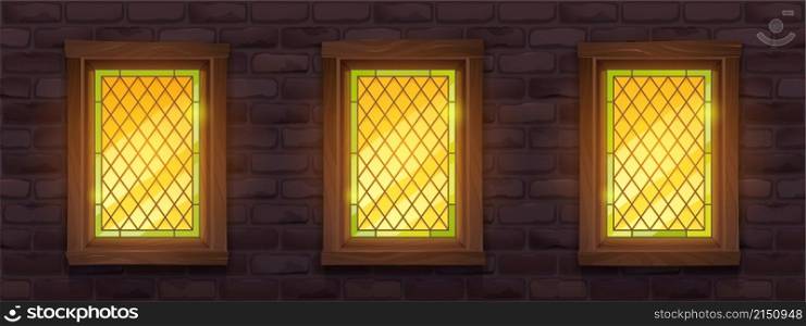 Old brick wall with glow stained glass windows at night. Vector cartoon illustration of medieval building facade with mosaic windows in wooden frame and stone wall. Old brick wall with glow stained windows at night