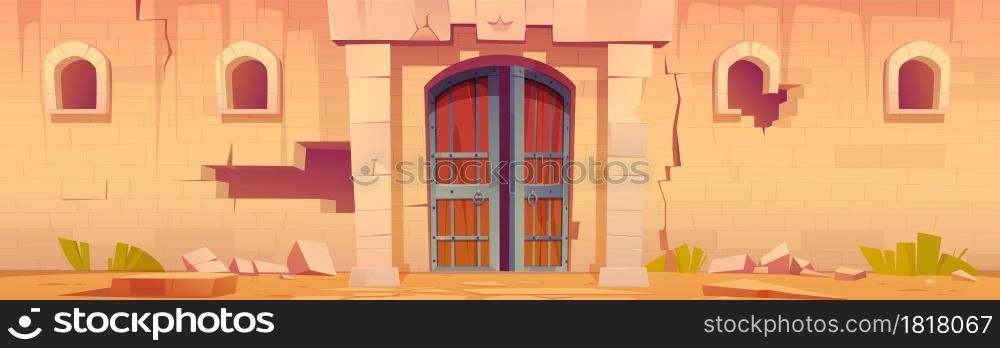 Old medieval castle with open wooden gates and broken stone wall. Vector cartoon illustration of abandoned fortress exterior with royal symbol above double doors, cracks and holes in wall. Old medieval castle with gates and broken wall