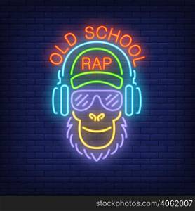Old school rap neon text and cool monkey in glasses and headphones. Neon sign, night bright advertisement, colorful signboard, light banner. Vector illustration in neon style.