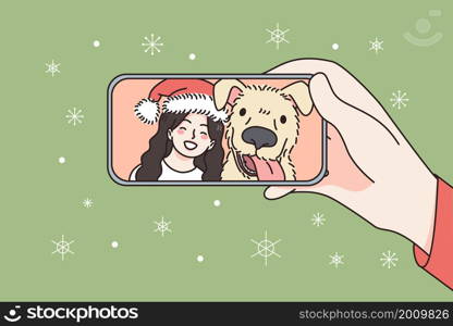 Online Christmas and New Year celebration concept. Human hand holding smartphone with smiling girl and dog in Santa hat celebrating and greeting online vector illustration . Online Christmas and New Year celebration concept.
