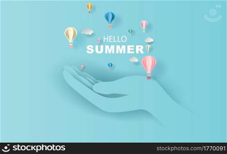 open the palm of the hand concept of balloon white floating and Gift Box on in the air blue sky background for Hello Summer hot and Festival poster. Creative paper craft and cut with Holiday season.