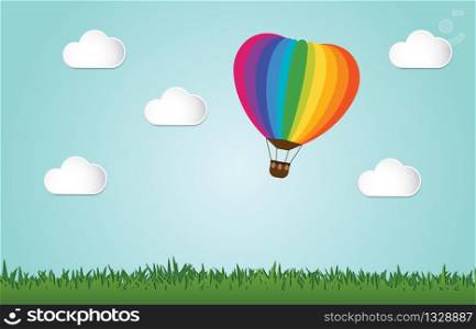 Origami made colorful hot air balloon fly over grass.paper art style.