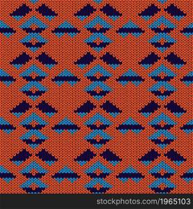 Ornate knitting seamless vector pattern in orange and blue hues as a fabric texture