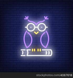 Owl on book neon sign. Clever owl in glasses sitting on book. Night bright advertisement. Vector illustration in neon style for education and literacy