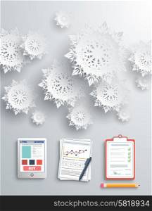 Paper snowflakes and clipboard smartphone documents on gray background
