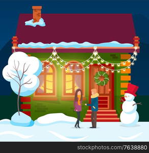 People standing by house decorated for winter holidays. Man and woman by building and snowman with bucket on head. Flat with pine tree glowing inside. New year or Christmas preparation and celebration. Couple Standing by Home with Garlands and Wreath