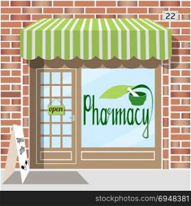 Pharmacy facade of red bricks.. Pharmacy facade of red bricks. Sticker with pharmacy symbol in the window. EPS 10 vector.