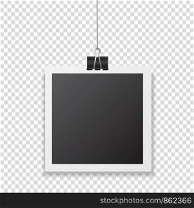 Photo frame with shadow hanging with paper clip. Black square snapshot and metal blinder isolated on transparent background. Vector silver paperclip on picture for your design