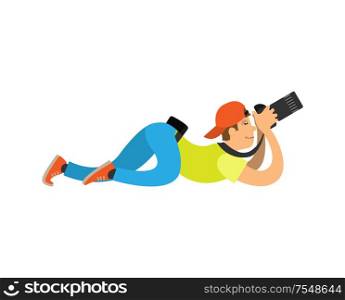 Photographer in cap lying on floor and recording video or taking photo with modern digital camera. Man making picture, powerful zoom device vector. Photographer in Cap Lying on Floor Recording Video