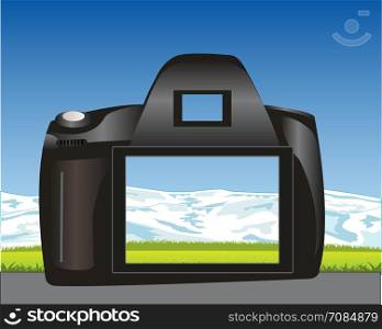 Photographic device and nature. Camera takes pictures landscape with mountain and glade