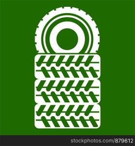 Pile of tires icon white isolated on green background. Vector illustration. Pile of tires icon green