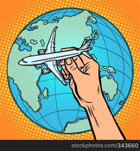 plane in hand. metaphor of flight to the Eastern hemisphere. Comic cartoon pop art vector retro vintage drawing. plane in hand. metaphor of flight to the Eastern hemisphere