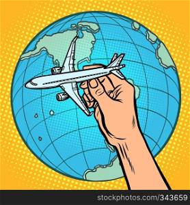 plane in hand. metaphor of flight to the Western hemisphere. Comic cartoon pop art vector retro vintage drawing. plane in hand. metaphor of flight to the Western hemisphere