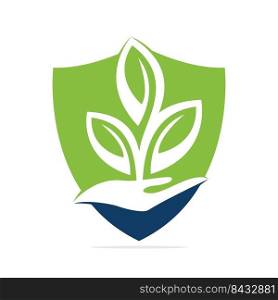 Plant in Hand Vector Logo Design. Natural Products in Shield Shape. Cosmetics and Spa logo. 