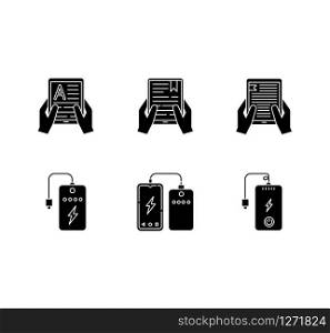 Portable electronic devices black glyph icons set on white space. Power bank. Portable battery. Charging gadget. Hands holding e-readers, tablets. Silhouette symbols. Vector isolated illustration