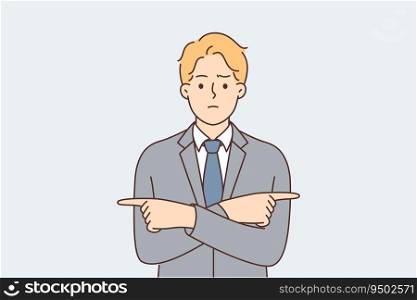 Puzzled business man points fingers in different directions and tries to make difficult decision choosing from two options. Metaphor of crossroads in business and need to make choice. Puzzled business man points fingers in different directions and tries to make difficult decision