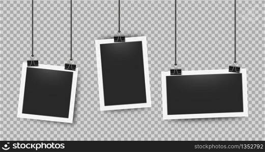 Realistic photo frames clipped on ropes. Retro 3D picture frame on white border for cameras photography. Vector illustration blank photoframe set on transparent background. Realistic photo frames clipped on ropes. Retro 3D picture frame on white border. Vector blank photoframe set