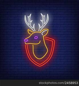Reindeer head on shield neon sign. Taxidermy and hunt design. Night bright neon sign, colorful billboard, light banner. Vector illustration in neon style.