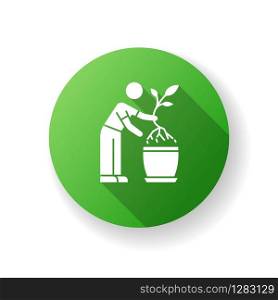Replanting green flat design long shadow glyph icon. Houseplant caring. Transplanting, repotting. Plant growing. Potting plant, changing planter. Planting seedling. Silhouette RGB color illustration