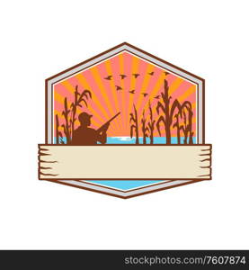 Retro style illustration of a duck or bird hunter with rifle in flooded cornfield with corn stalks set inside crest, shield or badge with sunburst on isolated background.. Duck Hunter in Cornfield Shield Retro