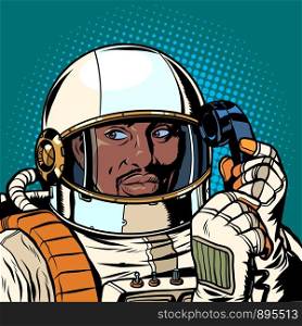 serious african astronaut talking on a retro phone. Pop art retro vector illustration drawing. serious african astronaut talking on a retro phone