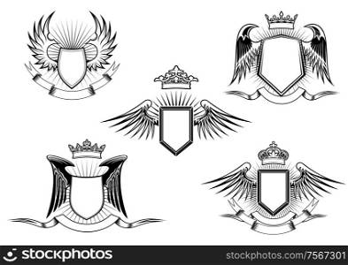 Set of five black and white vintage heraldic winged shields in different shapes with crowns above the shield and a blank banner below, detailed calligraphic design elements. Set of heraldic winged shields