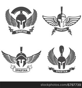 Set of the spartan helmets with wings. Design elements for logo, label, emblem, sign, brand mark. Vector illustration.