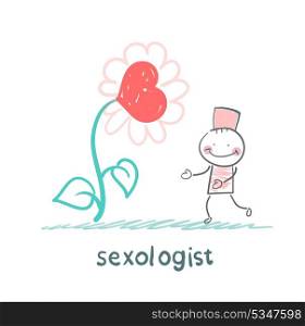 Sexologist stands near a large flower with a heart