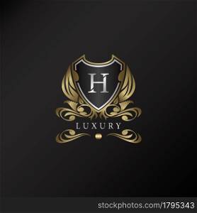 Shield logo in gold color with letter H Logo. Elegant logo vector template made of wide silver alphabet font on shield frame ornate style.