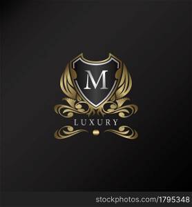Shield logo in gold color with letter M Logo. Elegant logo vector template made of wide silver alphabet font on shield frame ornate style.