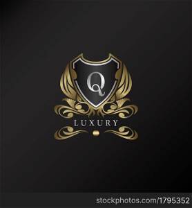 Shield logo in gold color with letter Q Logo. Elegant logo vector template made of wide silver alphabet font on shield frame ornate style.