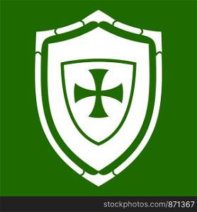 Shield with cross icon white isolated on green background. Vector illustration. Shield with cross icon green